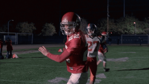 Cheerleader in WMHS Uniform Next to Man in Red Sweater