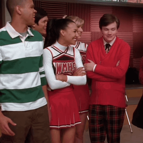 Cheerleader in WMHS Uniform Next to Man in Red Sweater
