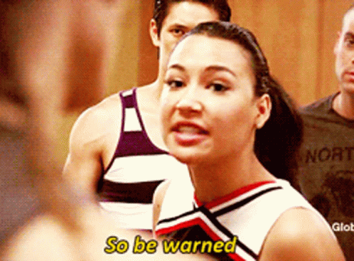 Cheerleader Says So Be Warned in Front of Man in Norte Shirt