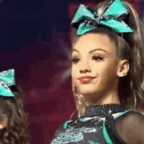 Cheerleader With Green Bow Smiling GIF