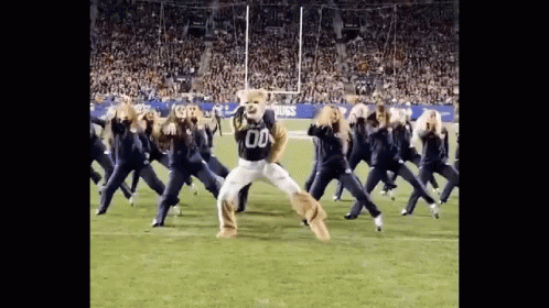 Cheerleaders Dancing With Mascot in Number 00 Jersey