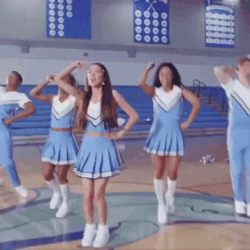 Cheerleaders in Blue Uniforms Dancing