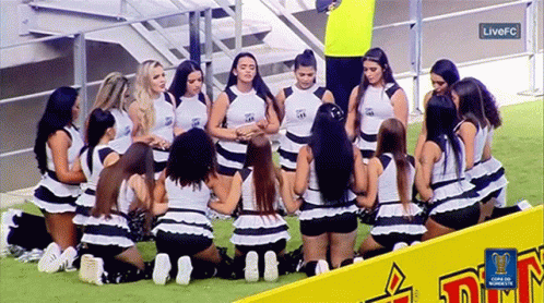 Cheerleaders Kneeling on Field with FC Logo