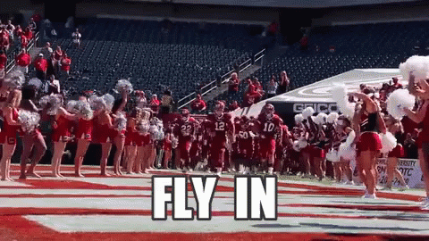 Cheerleaders Leading Football Team