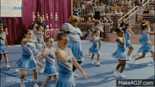 Cheerleaders Performing In Front Of County Junior Sign GIF