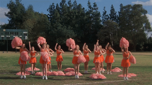 Cheerleaders Performing in Front of Guest Scoreboard