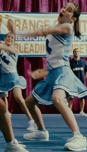 Cheerleaders Performing In Front Of Orange County Sign GIF