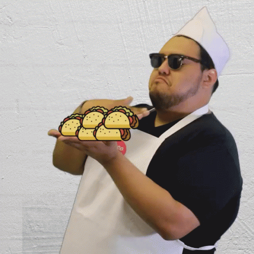 Chef Holding Stack of Tacos