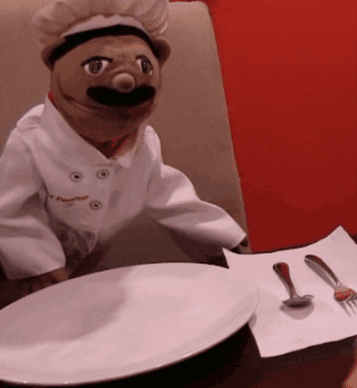Chef Puppet at Table With Plate and Spoons