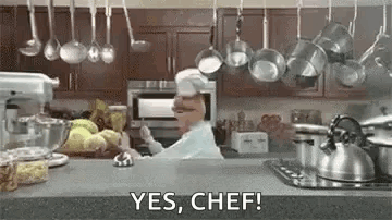 Chef Saying Yes Chef With Hanging Pots Pans