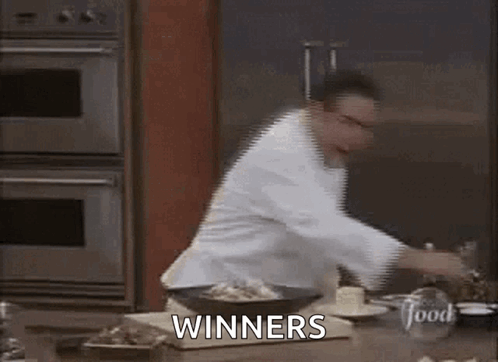Chef Standing In Kitchen With Winners GIF