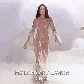 Cher in Long Dress with Arms Outstretched in Clouds