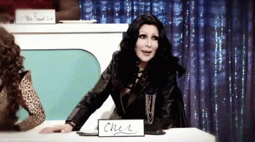 Cher With Sign Saying Cher