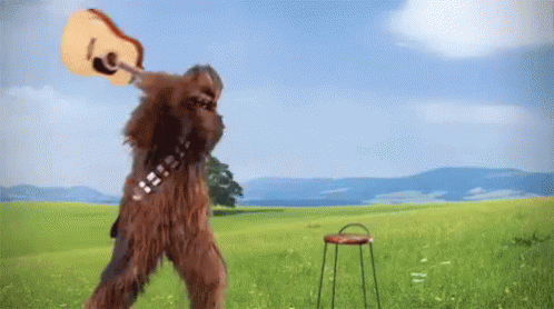 Chewbacca Holding Guitar In Field GIF