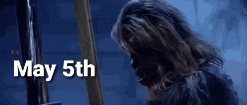 Chewbacca Is Standing In Front Of A Sign That Says May 5Th . GIF