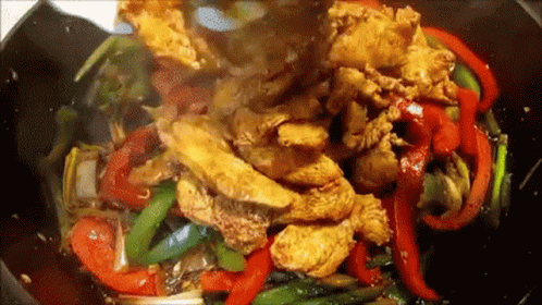 Chicken And Peppers Being Cooked In Wok With Sauce GIF