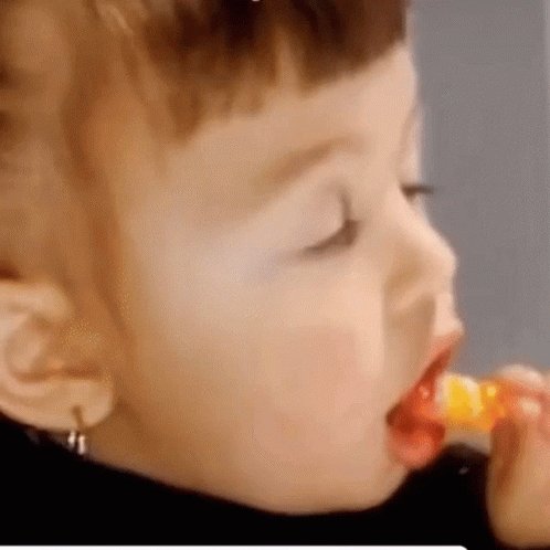 Child Eating Lollipop with Spoon