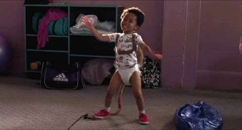 Child in Diaper Dancing in Front of Adidas Bag