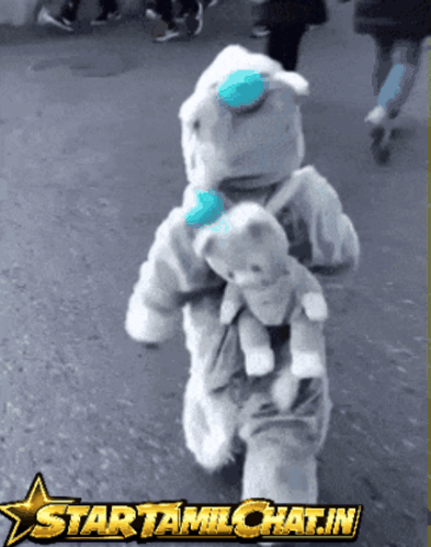 Child in Teddy Bear Costume Holding Teddy Bear