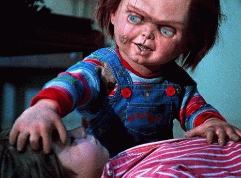 Child Laying On Bed With Chucky Doll GIF