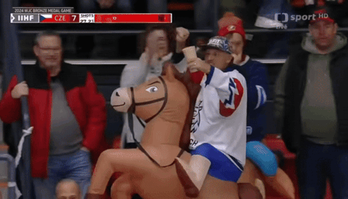 Child Riding Stuffed Horse At Hockey Game GIF