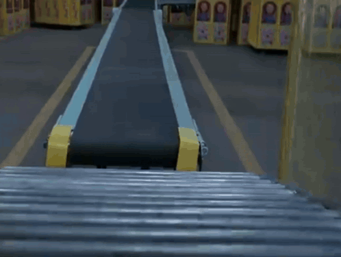 Child's Doll On Conveyor Belt In Factory GIF