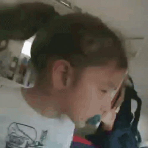 Child With Ponytail And Toothbrush In Mouth GIF