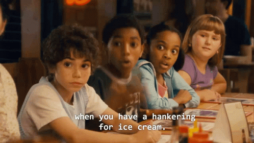 Children Sitting at Table With Ice Cream Craving