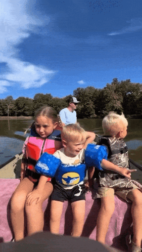 Children Sitting on Boat in Life Vests
