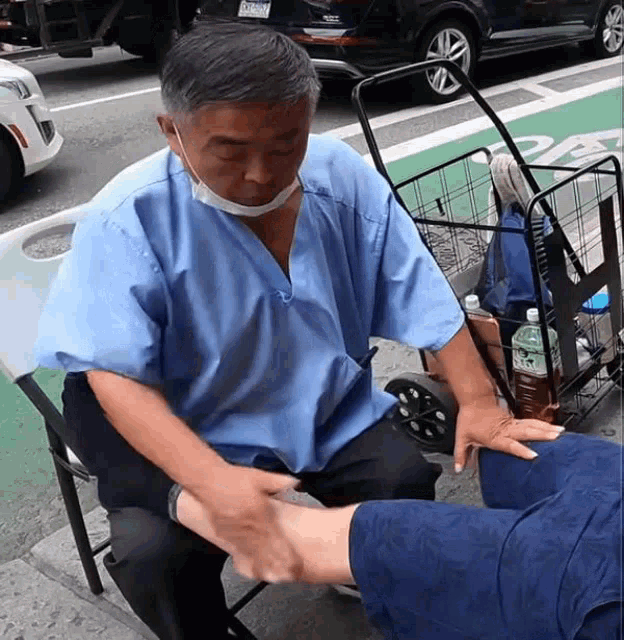 Chinese Guy On The Street Foot Massage Service GIF