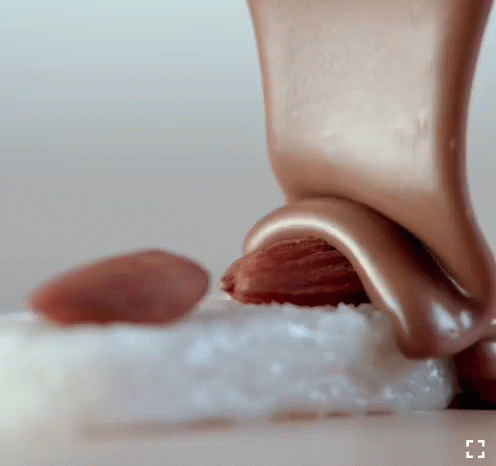 Chocolate Being Poured on Almond