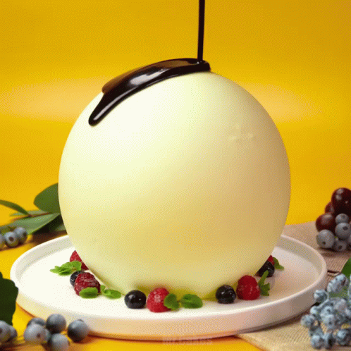Chocolate Being Poured Over White Ball GIF