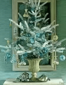 Christmas Tree With Blue Ornaments In Gold Vase GIF