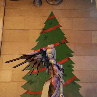 Christmas Tree With Red Ribbons Behind Angel Statue