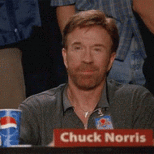 Chuck Norris Is Sitting At A Table With A Pepsi Can In The Background GIF