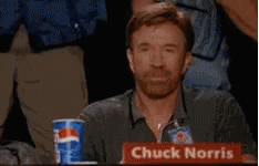 Chuck Norris Is Sitting At A Table With A Pepsi Cup In Front Of Him GIF