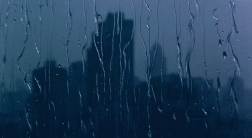 City Skyline Through Rainy Window