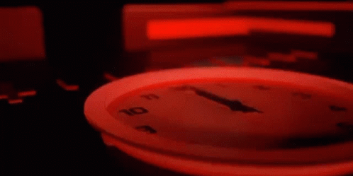 Close Up Clock With Red Light Around Face