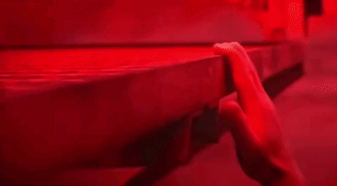 Close-up Hand on Table in Red Light