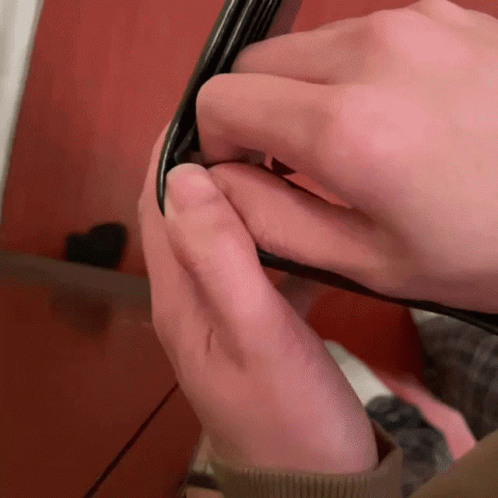 Close Up Hands Holding Black Object GIF
