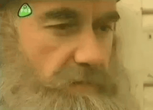 Close Up Man Face With Green Sticker GIF