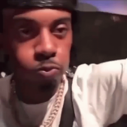 Close Up Man's Face With Hat And Chain GIF