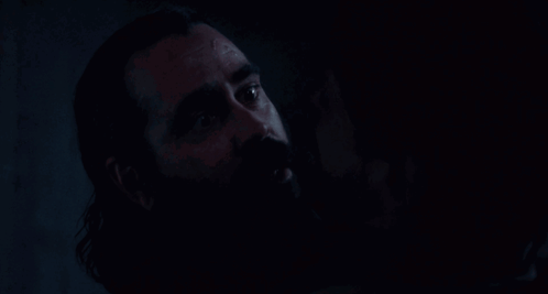 Close Up Man With Beard In The Dark GIF