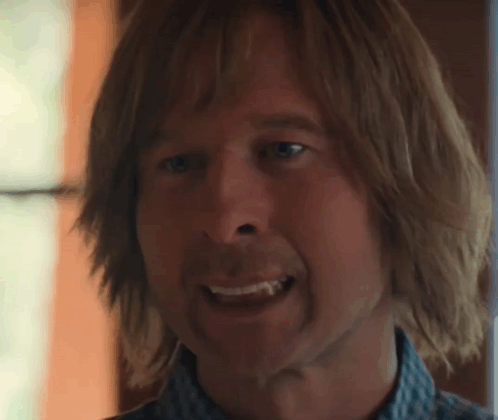 Close Up Man With Long Hair Showing Tooth