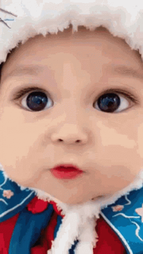Close Up of Baby Face Wearing Hat and Coat