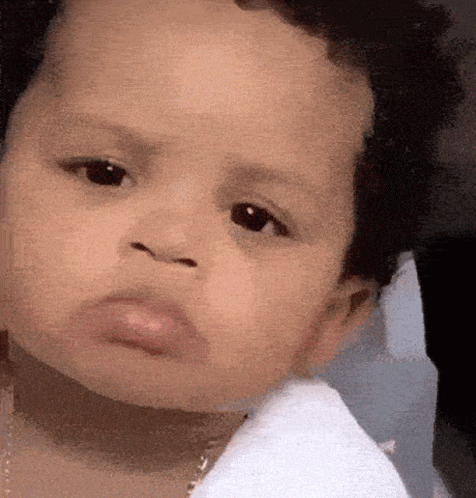 Close Up of Baby's Face in White Shirt