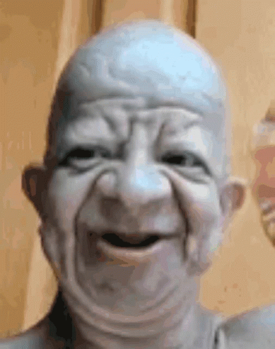 Close Up of Bald Old Man Statue Making Face