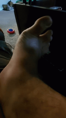 Close Up Of Foot With Red White Blue Object GIF