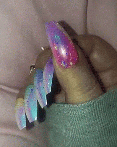 Close-up of Hand With Blue Nails and Silver Glitter