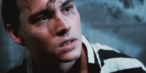 Close Up Of Man's Face In Black And White Striped Shirt GIF